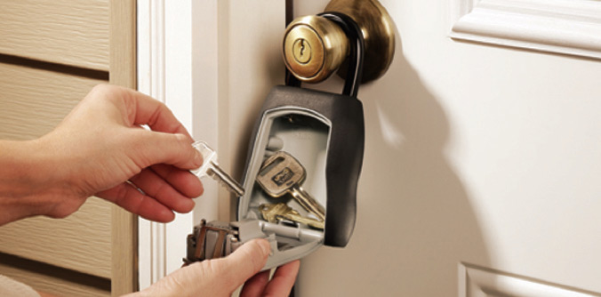 Hands removing keys from a lock box